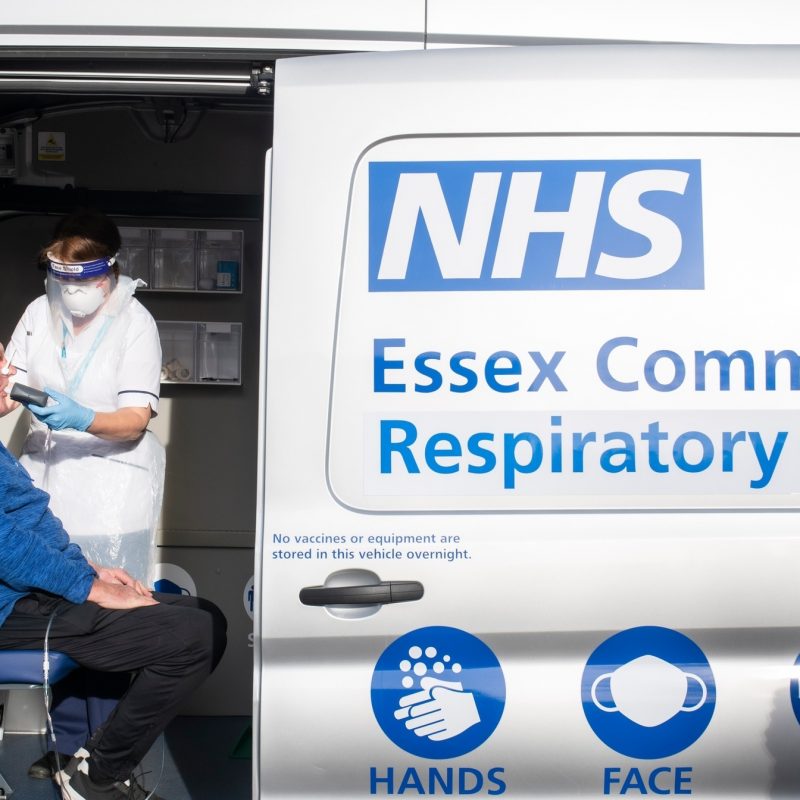Photo of a person sat in a van having a lung health check