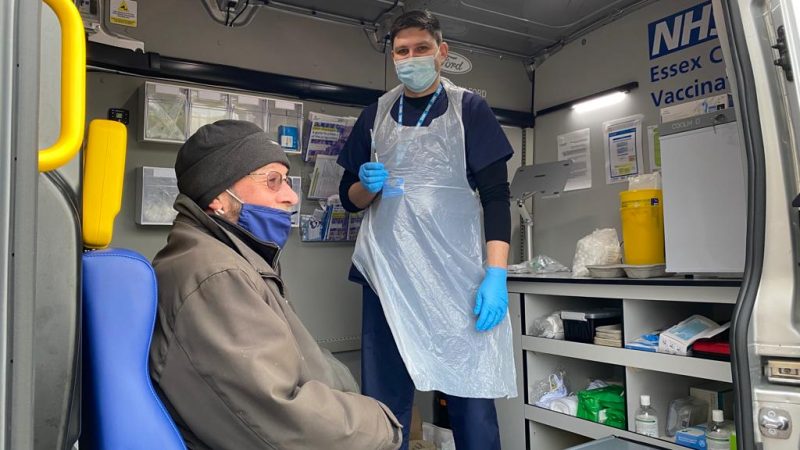 Physician Associate Dzmitry Sapa vaccinating Thorney Bay resident Dave Watson inside the Essex Vaccine Van