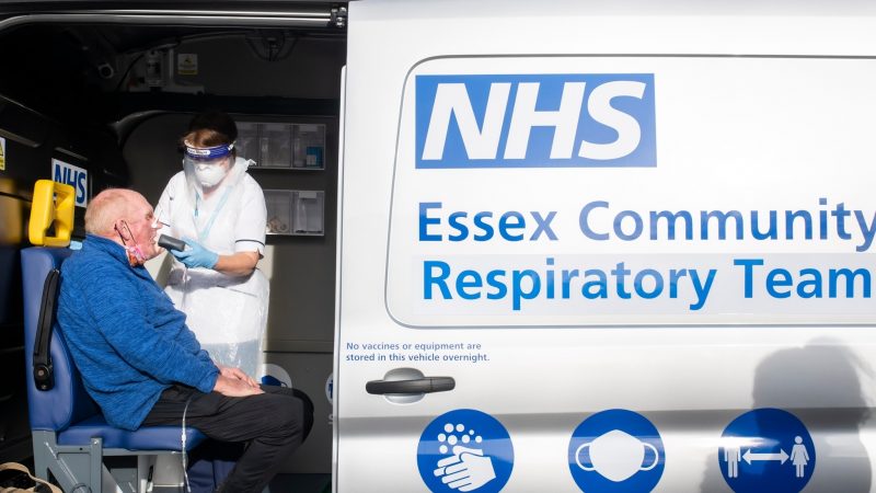 Photo of a person sat in a van having a lung health check